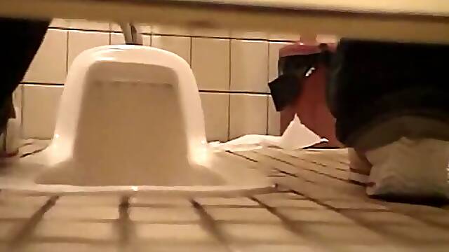 Pissing in the toilet and showing bushy pussy on spy cam
