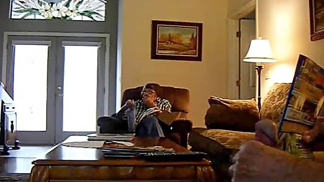 Jerking a big dick off while the granny reads her papers