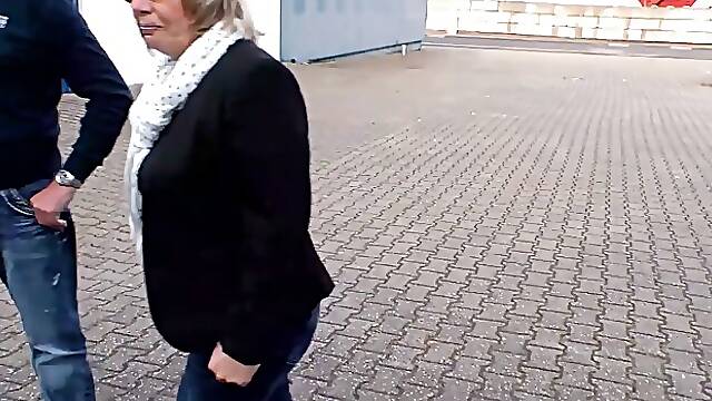 Mature German woman with big, saggy tits is cheating on her husband on the couch